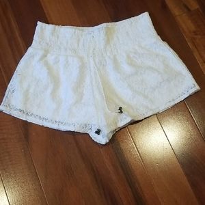 Fully lined white lace shorts.